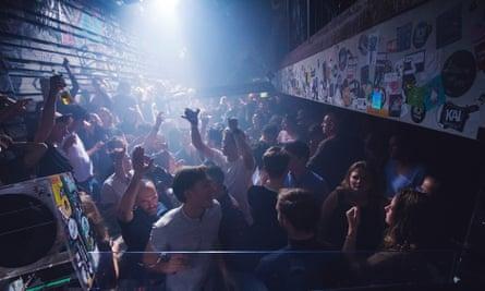 A packed dancefloor under strobing lights at Club NYX in Amsterdam.